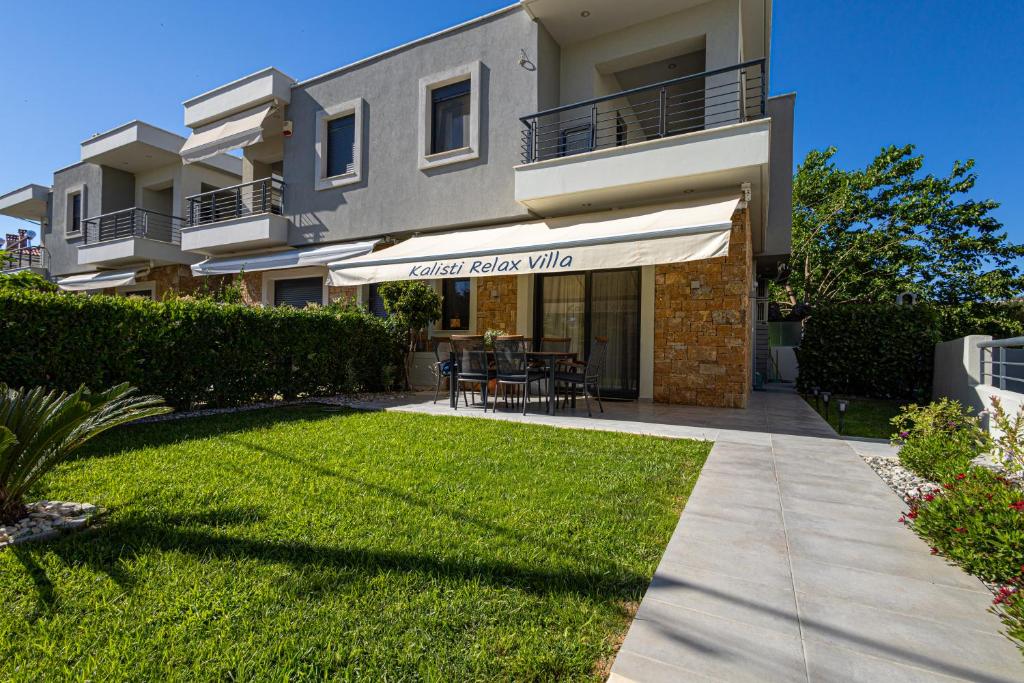 a house with a lawn in front of it at Kalisti Relax Villa in Nikiti