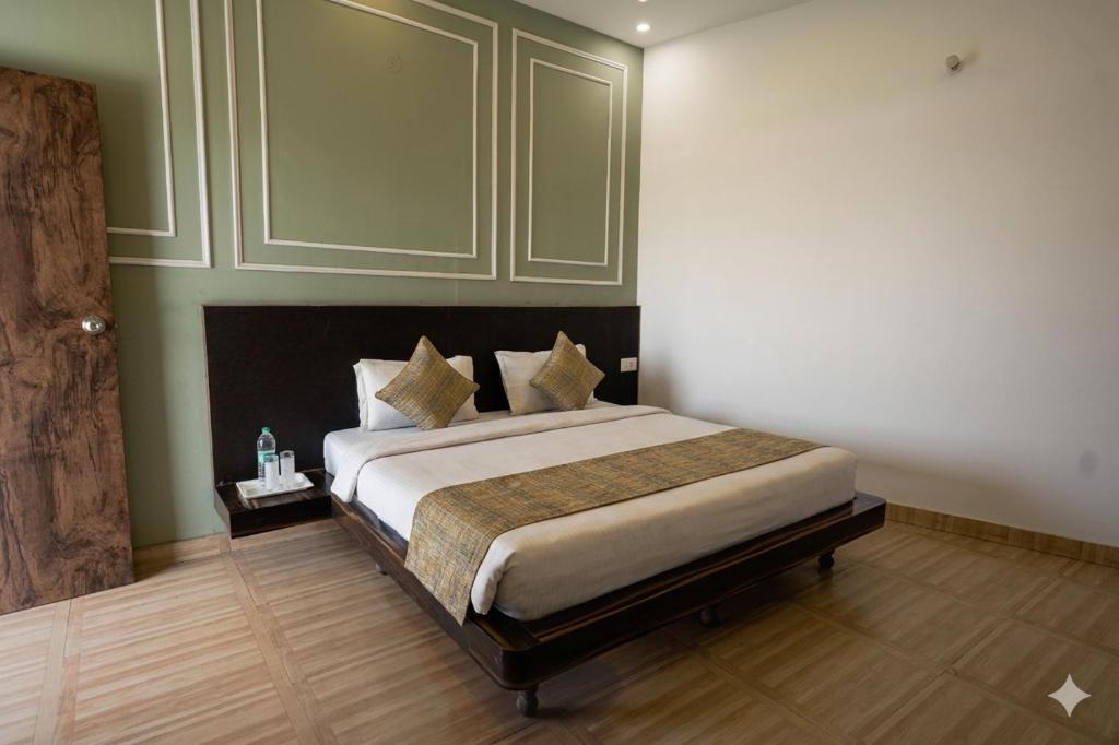 a bedroom with a large bed in a room at Gharonda Manor-A Home Beyond Home -Best Luxury Budget Stay Near ISBT in Dehradun