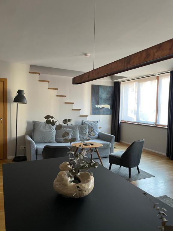 a living room with a couch and a table at Maironis 2 - Grand Apartment in the Heart of Kaunas in Kaunas