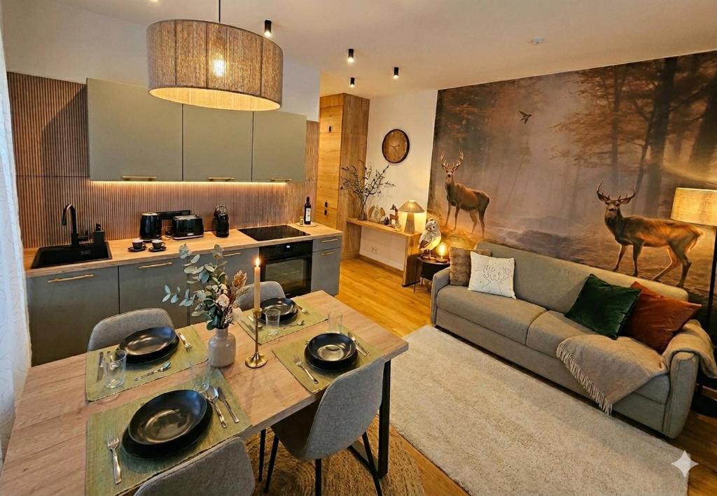 a kitchen and living room with a couch and a table at Residence Marianka in Albrechtice v Jizerských horách