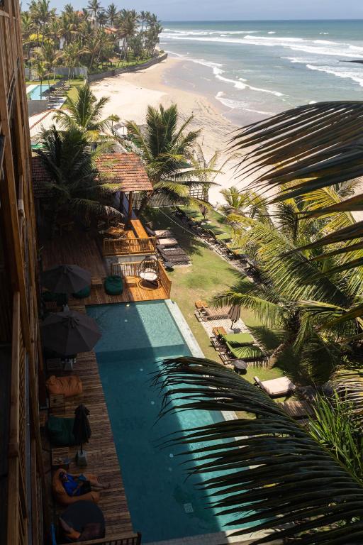 an overhead view of a swimming pool next to a beach at Coast 67 Boutique Hotel in Ahangama