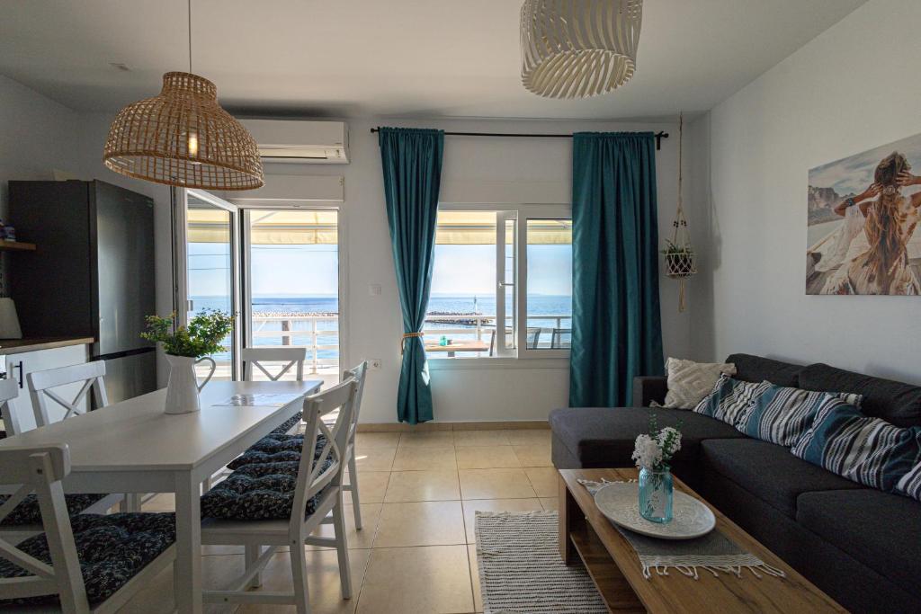 a living room with a couch and a table at Kima Sea Apartment in Nikiti