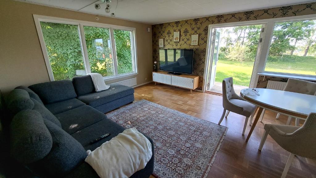 a living room with a blue couch and a table at Villa Skäris in Falkenberg
