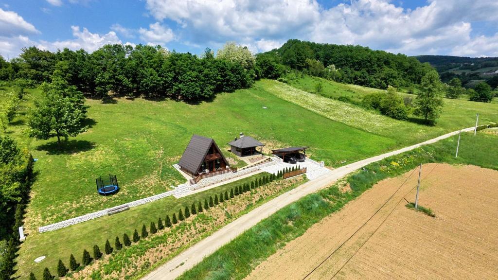 an overhead view of a house on a green field at A frame Svetosavska bajka in Lisice