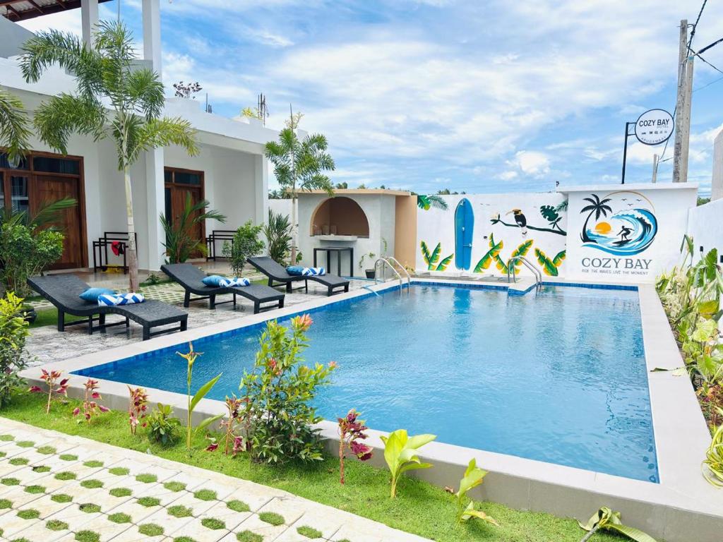 a swimming pool in the yard of a house at Cozy Bay Hotel in Arugam Bay
