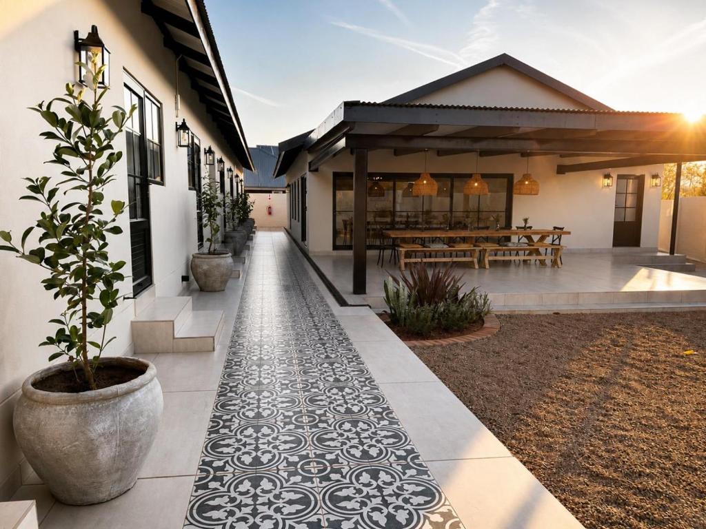 a house with a courtyard with a potted plant at Hanan Guesthouse in Thabazimbi