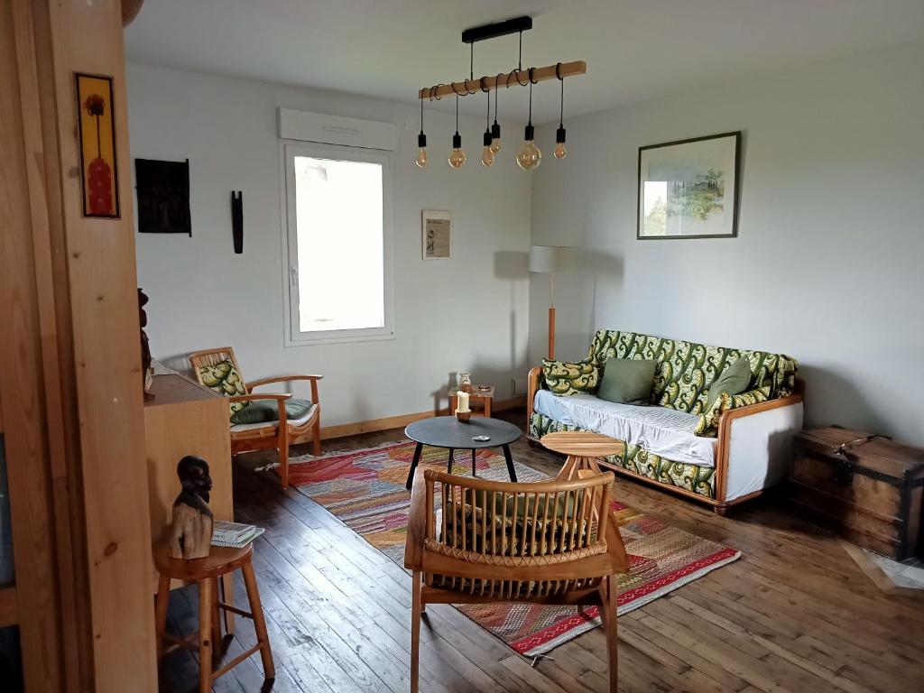 a living room with a couch and a table at Chez Mekki in Châteauponsac