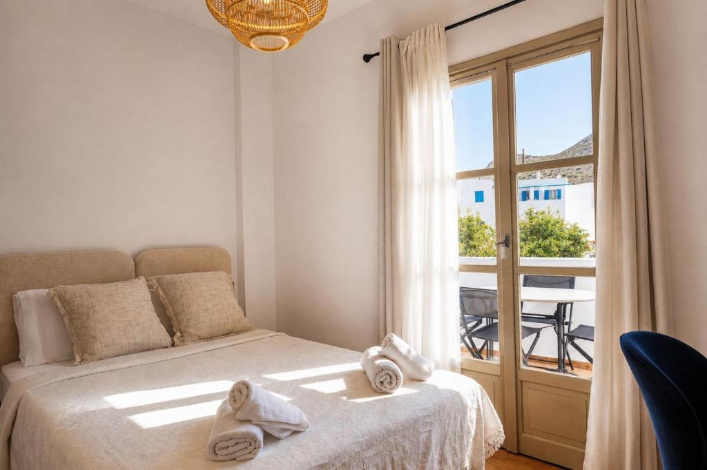 a bedroom with a bed with towels on it at Azure Sea House in Avlemonas