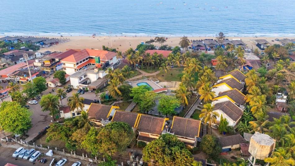 an aerial view of a beach with houses and the ocean at Calangute Residency in Calangute