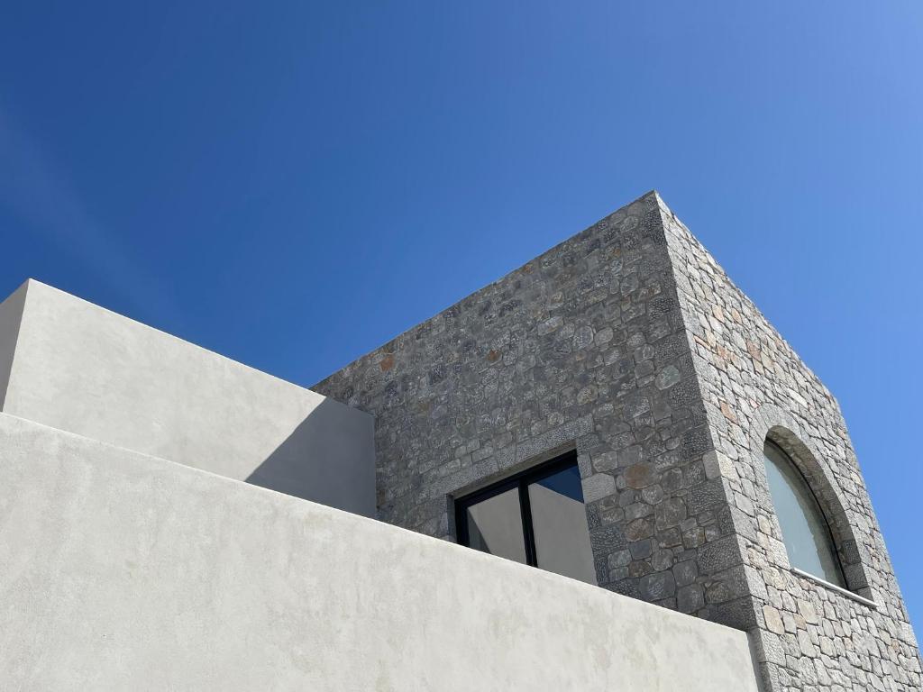 a stone building with a window on top of it at KITO suites in Kitriaí