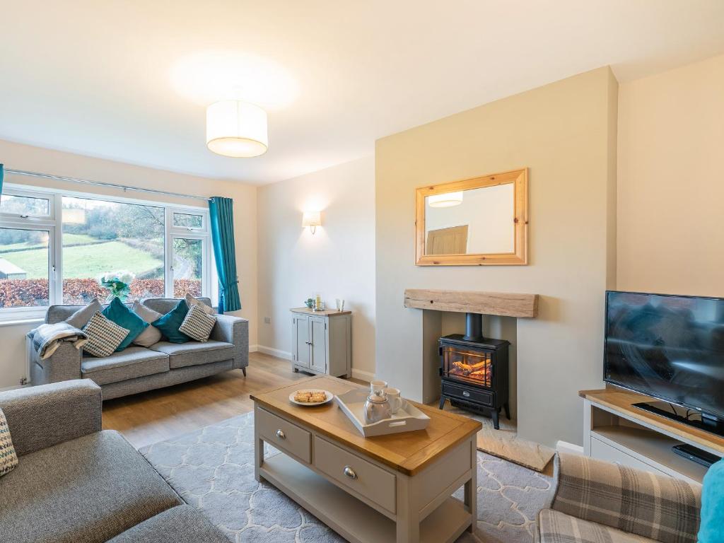 a living room with a couch and a fireplace at Carr View Farm in Bamford