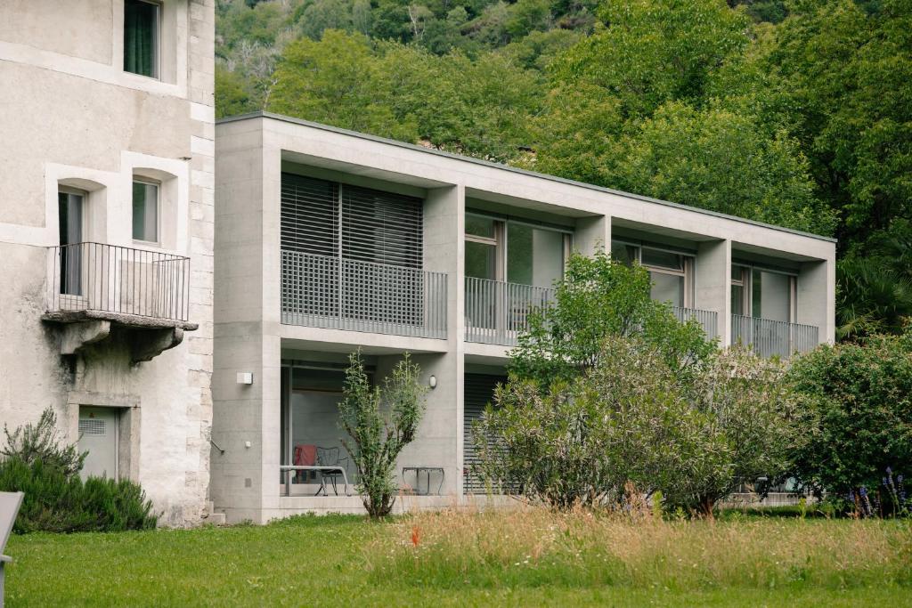 a building with balconies on the side of it at Casa Martinelli, Boutique-Hotel in Maggia
