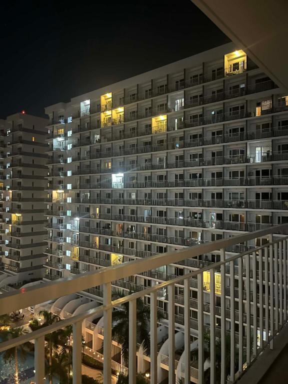 a large apartment building at night with lights at Shell Staycation in Manila