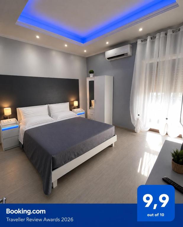 a bedroom with a large bed with a blue ceiling at Bellavista B&B in Roccavivara