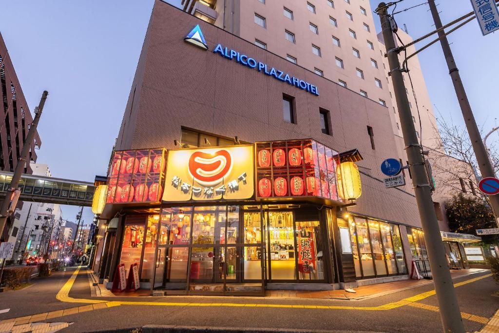 a store front of a building on a city street at Alpico Plaza Hotel in Matsumoto