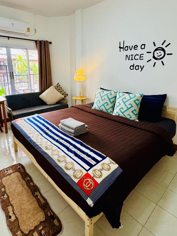 a bedroom with a large bed with a nice day sign on the wall at Happy Home Samui near Mae Nam beach on main road in Ban Mae Nam