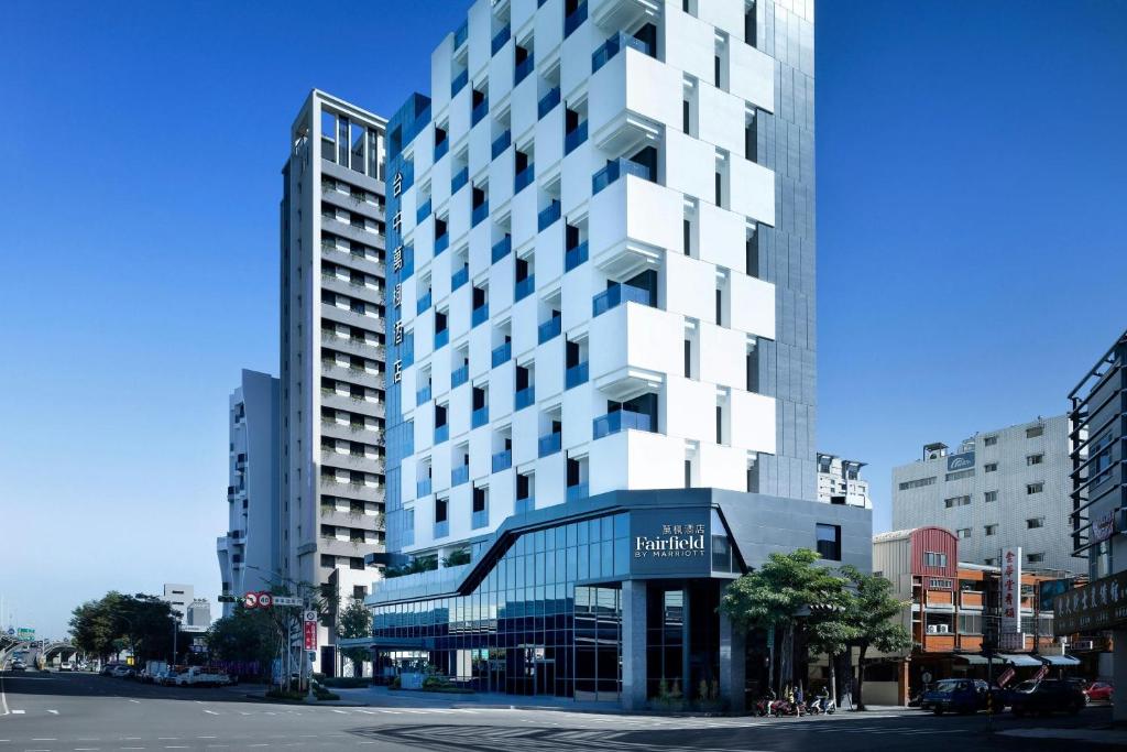a tall white building on a city street at Fairfield by Marriott Taichung in Taichung