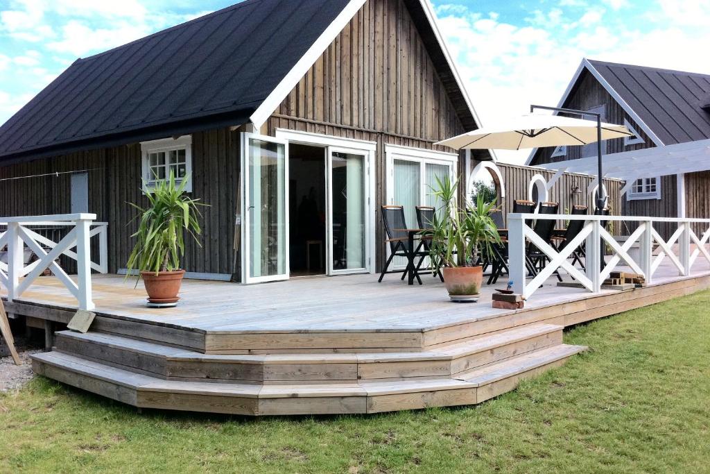 a large wooden deck with a house at The Aspö Hideaway in Drottningskär