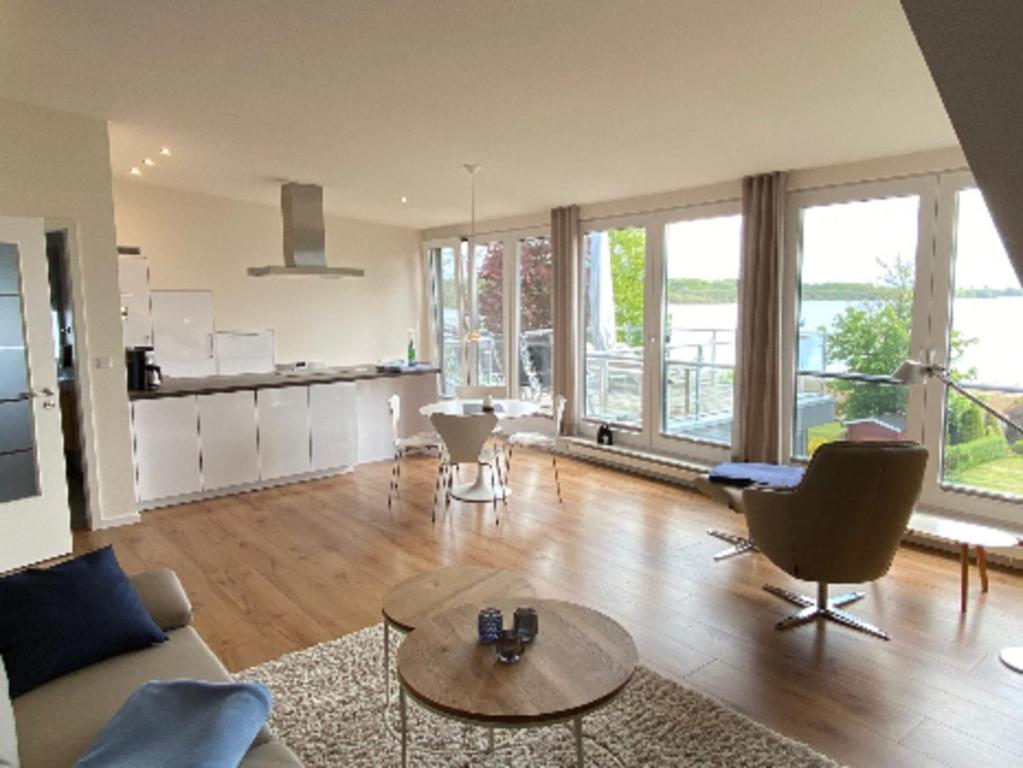 a living room with a couch and a table at Seepanorama in Groß Wittensee