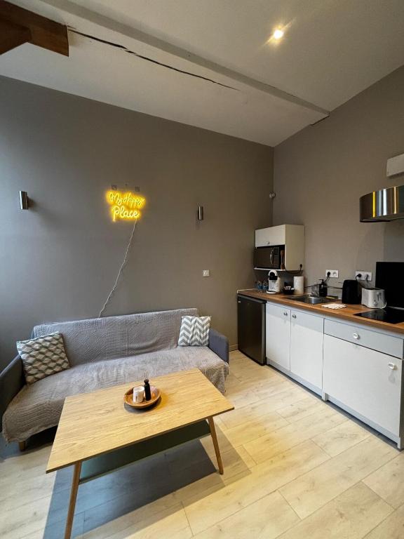 a living room with a couch and a table at Le Moderne - 2 Voyageurs in Rouen
