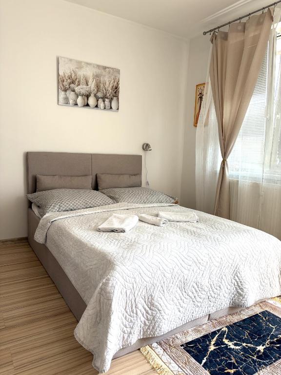 a bedroom with a bed and a window at Chic & Cozy Beige Studio in Bratislava