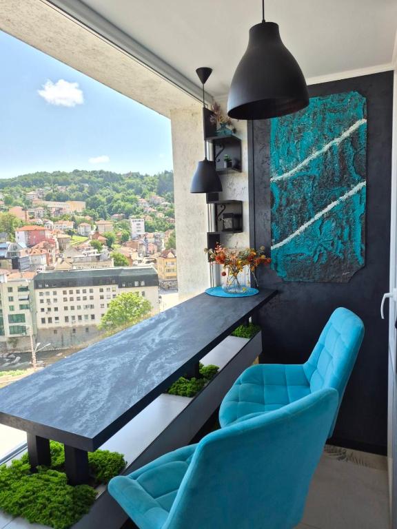 a dining room with a table and blue chairs at Balkan tower REST 2 Безплатно паркомясто in Gabrovo