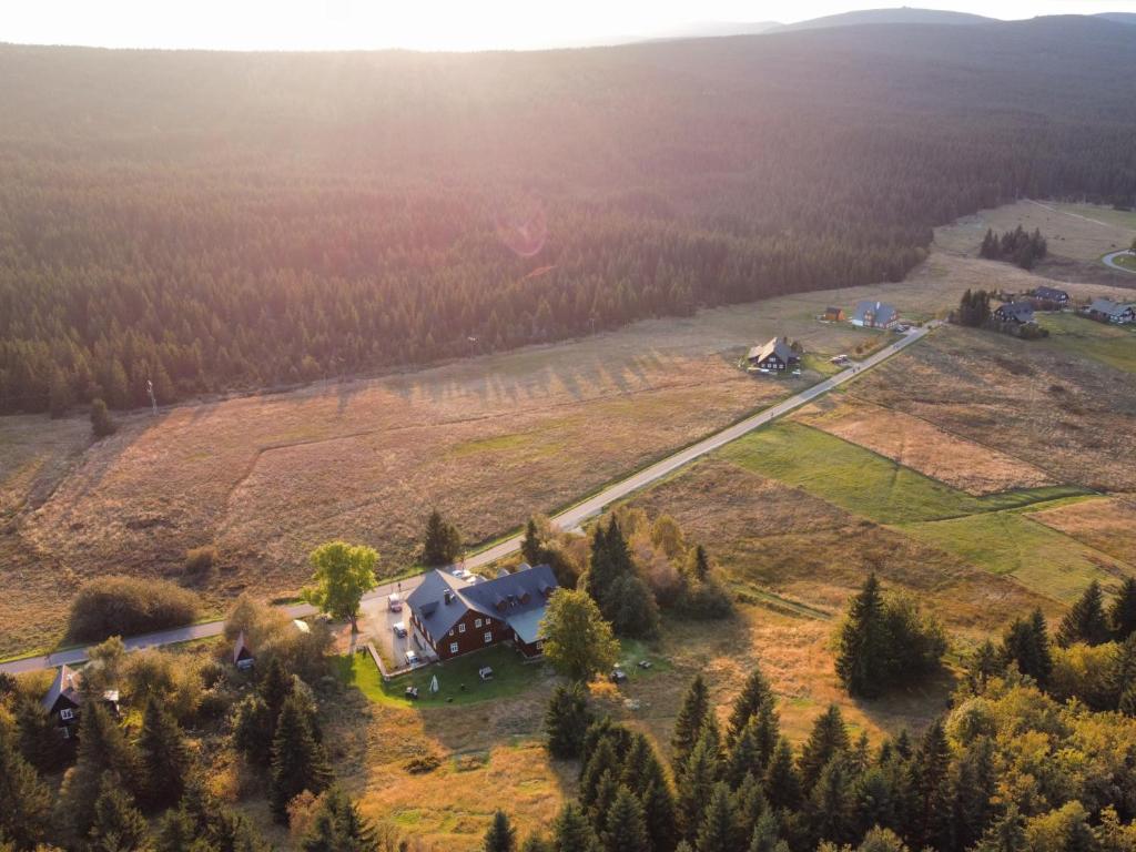 an aerial view of a house on a field with trees at Hotel Jizerka 4 in Jizerka