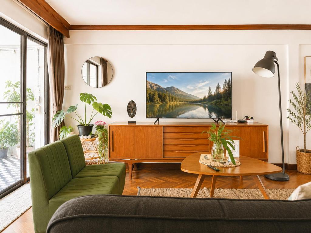 a living room with a couch and a tv at Pannarai's House in Bangkok