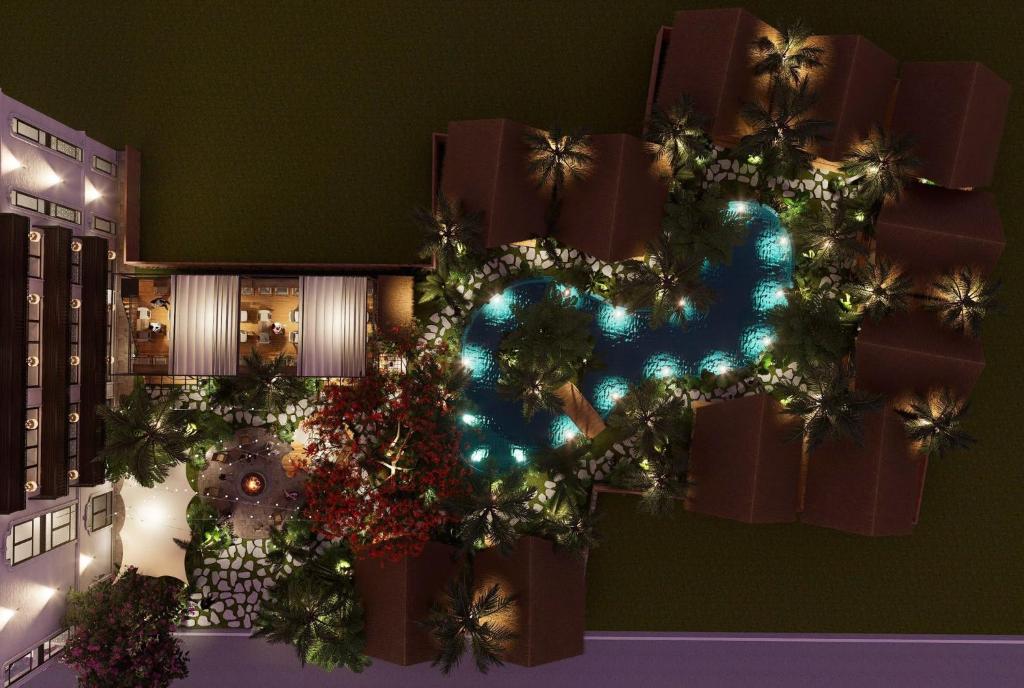 a christmas tree with lights and presents on a wall at Mai Homestay in Ninh Binh