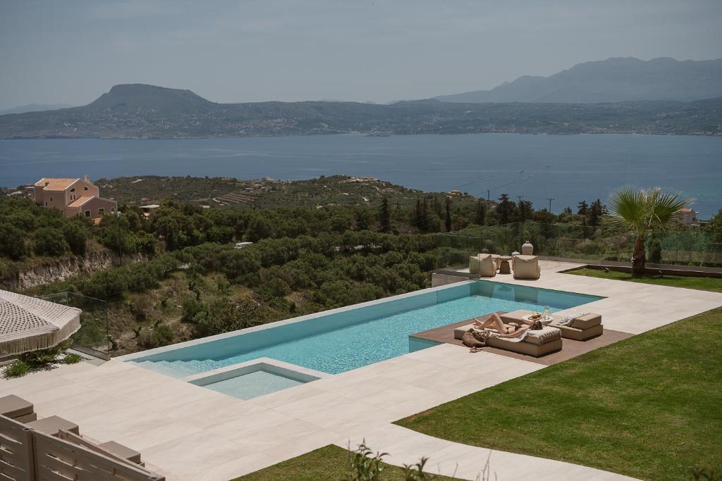 a swimming pool with a view of the water at Villa Niolos II in Stérnai