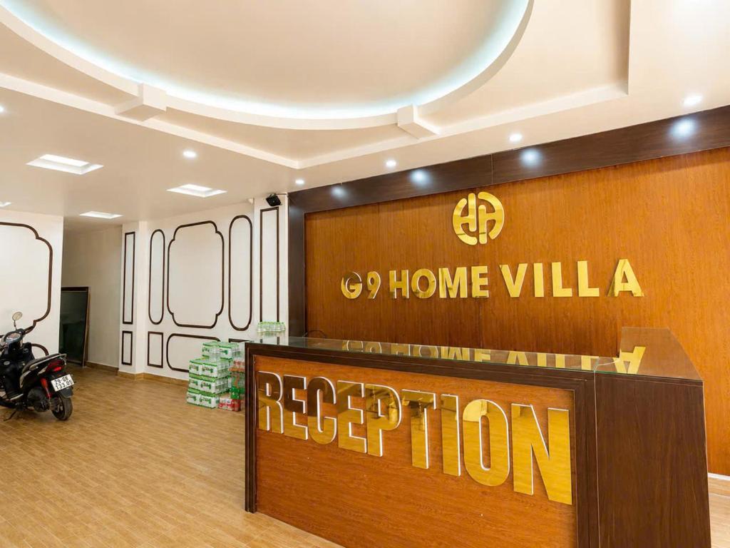 a hotel lobby with a reception desk and a sign at G9 home hotel in Hanoi