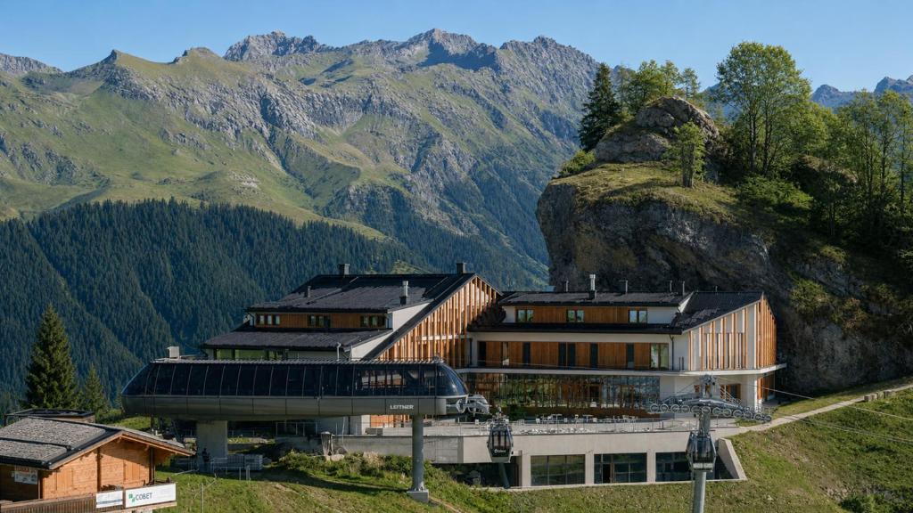 a building on a hill with mountains in the background at Rifugio Colere 1600 by Cloud 7 in Colere
