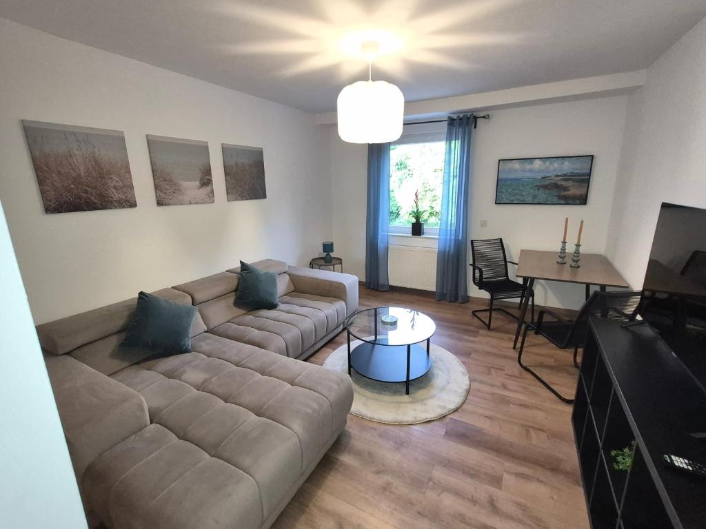 a living room with a couch and a table at FeWo Carolina in Püttlingen