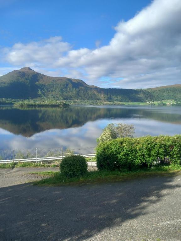 a view of a lake with a mountain in the background at Fjord & Fjell Idyll in Tunheim