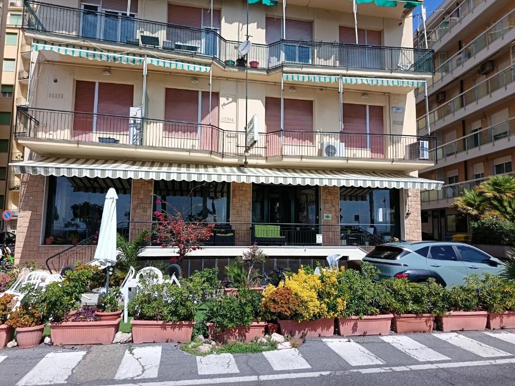 a building with a bunch of plants in front of it at HOTEL GIORDANA in Loano