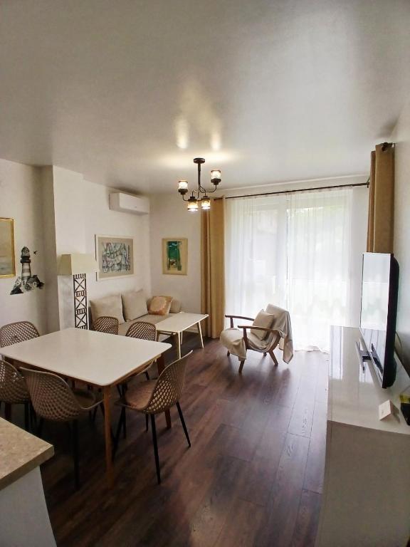 a living room with a table and a couch at Аpartment Van Gogh in Hisarya