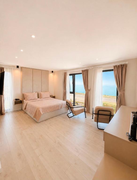 a bedroom with a bed and a view of the ocean at THE DECK OTEL in Trabzon