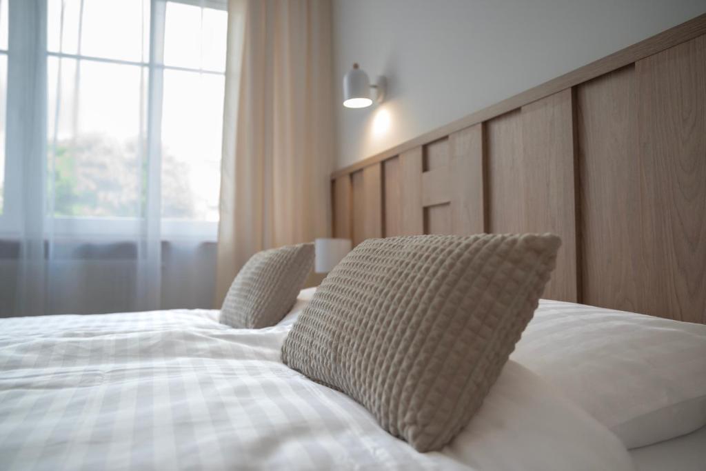 a bedroom with a bed with two pillows on it at Pokoje ABC Centrum in Ustka