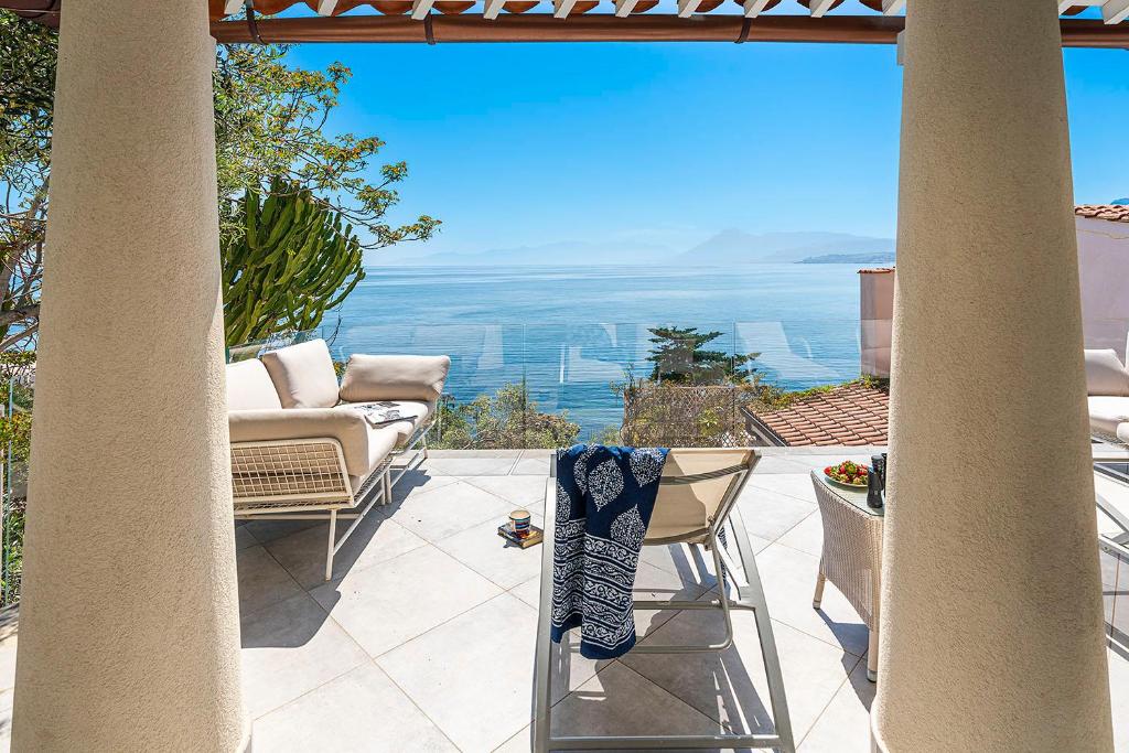 a patio with a view of the ocean at Casa Mamà private access to sea in Santa Flavia