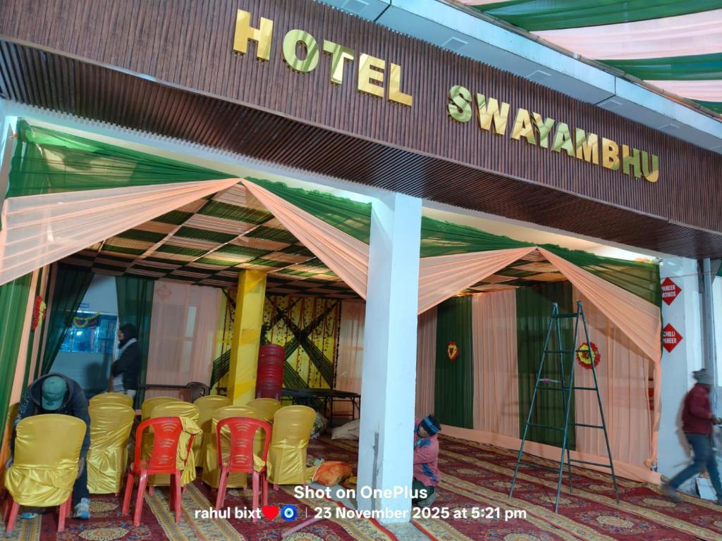 a hotel with a bunch of chairs in front of it at Swayambhu Hotel in Rudraprayāg