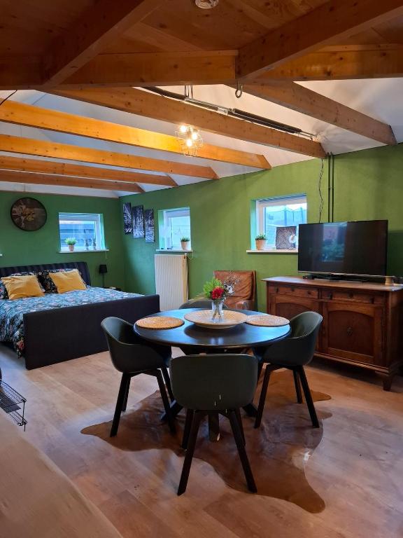a living room with a table and a couch at Drenthse Klaver in Borger in Borger
