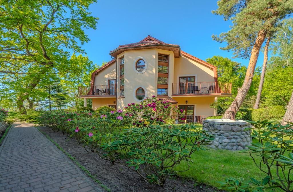 a house with a pathway in front of it at Wy & Spa in Pobierowo