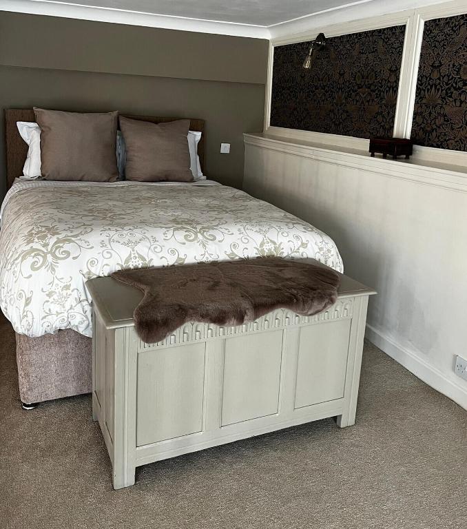 a bedroom with a bed with a blanket on it at Carnegie Library: Bronte Apartment 1 Bedroom in Swinton