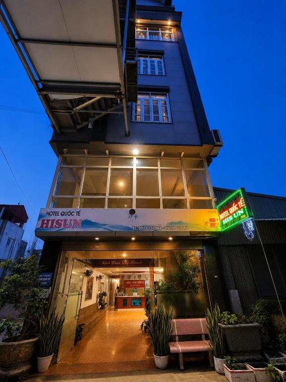 a building with a sign in front of it at Hisun Hotel Quốc tế - Đông Anh in Thụy Ha