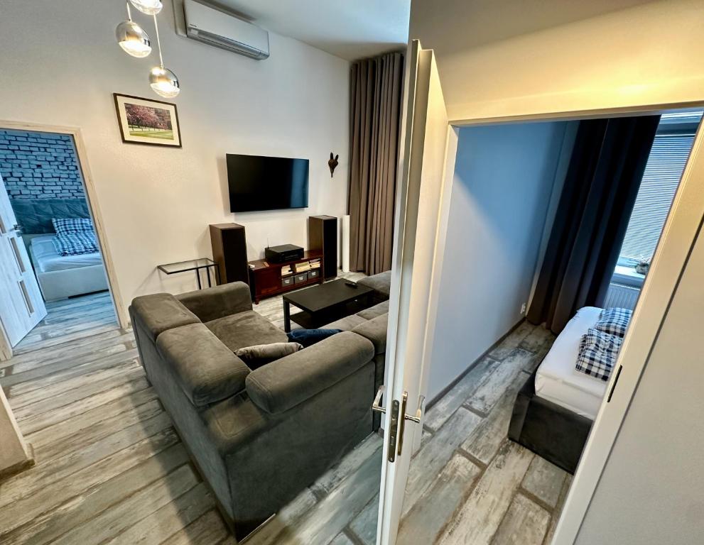 a living room with a couch and a television at Royal City Centre Apartment - 2 Bedrooms 72 m2 - AC - Balcony - Coffee Machine - Washer - Dryer -Parking available Free public or Paid Private for 20 euro per stay Please read our emails in Poprad