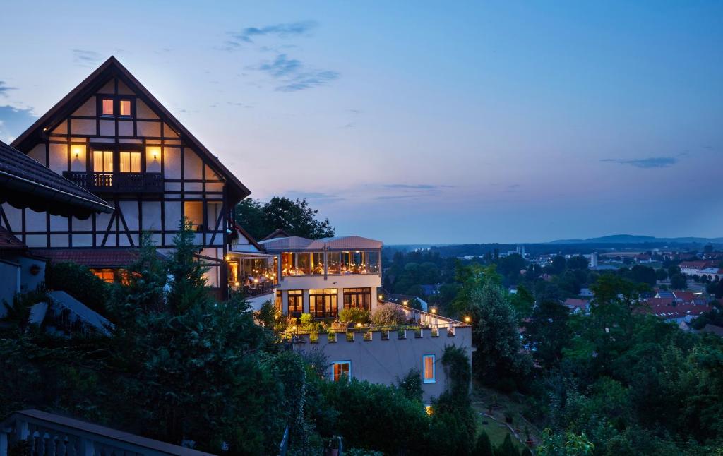 a house on top of a hill at night at BoutiqueHotel KAPUZINERGARTEN in Breisach am Rhein