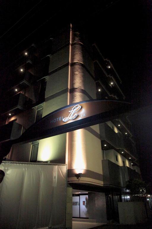 a tall building with a sign on it at night at HOTEL K's L Adult only in Urigōchō