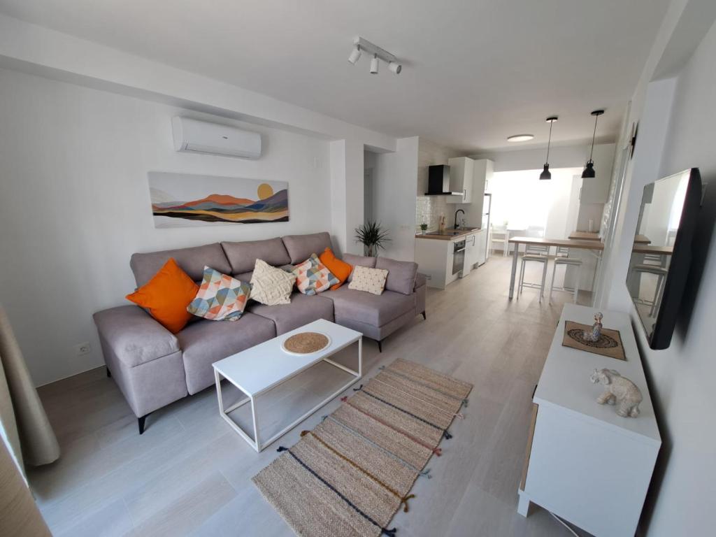 a living room with a couch and a table at Davinia apartamento centro in Nerja