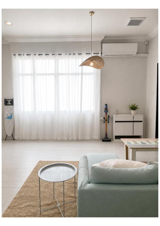 a living room with a couch and a table at UMii Homestay in Tawau