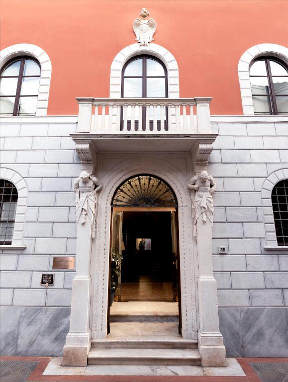 an entrance to a building with a balcony on top at Albergo Pietrasanta in Pietrasanta